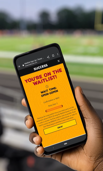 a hand holding a mobile phone