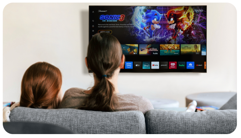 two people looking at a tv